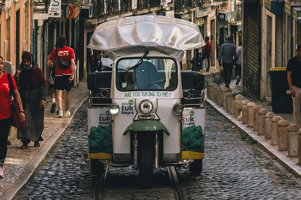 Un tuk-tuk dans une rue pavée de Lisbonne